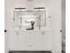 A bathroom with a double vanity, white cabinets, and modern fixtures, providing a clean and elegant space at 4201 Vallejo St, Denver, CO 80211