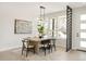 Dining room with a modern light fixture, artwork, windows, and stylish chairs around a wooden table at 4201 Vallejo St, Denver, CO 80211