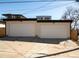 Two-car garage with modern doors and exterior lighting, providing ample parking and storage at 4201 Vallejo St, Denver, CO 80211