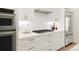 Modern kitchen featuring white cabinets, stainless steel appliances, and a gas range stove at 4201 Vallejo St, Denver, CO 80211