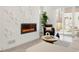 Stylish living room featuring an electric fireplace, modern decor, and access to the patio at 4201 Vallejo St, Denver, CO 80211