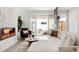 Bright living room with a modern fireplace and access to an outdoor patio at 4201 Vallejo St, Denver, CO 80211