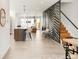 Open-concept living space featuring a modern kitchen, staircase, and stylish interior design elements at 4201 Vallejo St, Denver, CO 80211