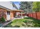 Relaxing backyard features a covered patio, green lawn, and mature trees for outdoor enjoyment at 8201 Allison Ct, Arvada, CO 80005