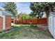 Spacious backyard with green lawn, garden beds, and privacy fence is perfect for outdoor activities at 8201 Allison Ct, Arvada, CO 80005