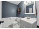 Charming half bath with a modern sink, decorative mirror, and wainscoting at 8201 Allison Ct, Arvada, CO 80005