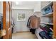 A well-organized walk-in closet with shelving, hanging rods, and a window for natural light at 8201 Allison Ct, Arvada, CO 80005