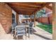 Charming covered patio with a dining table, ideal for outdoor entertaining and relaxation at 8201 Allison Ct, Arvada, CO 80005