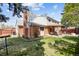Charming exterior of home with covered patio and a well-manicured backyard at 8201 Allison Ct, Arvada, CO 80005