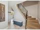 Inviting foyer with stairs, tile floors, and a welcome sign at 8201 Allison Ct, Arvada, CO 80005