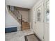 Light and airy foyer with a staircase, tile floors, and a beautiful front door at 8201 Allison Ct, Arvada, CO 80005