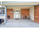 Cozy front porch features brick accents, neutral paint, and space for seating at 8201 Allison Ct, Arvada, CO 80005
