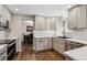 Modern kitchen featuring white cabinets, stainless steel appliances, and hardwood floors at 8201 Allison Ct, Arvada, CO 80005