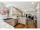 Bright kitchen featuring white cabinets, quartz countertops, stainless steel appliances, and modern finishes at 8201 Allison Ct, Arvada, CO 80005
