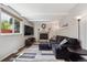 Cozy living room features a fireplace, exposed beams, and plenty of natural light at 8201 Allison Ct, Arvada, CO 80005