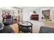 Open living space with hardwood floors, a decorative piano, and large picture window at 8201 Allison Ct, Arvada, CO 80005