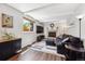 Comfortable living room with a cozy fireplace, beamed ceilings, and lots of natural light at 8201 Allison Ct, Arvada, CO 80005