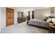 A spacious main bedroom featuring a large bed, stylish wooden furniture, and a neutral color palette at 8201 Allison Ct, Arvada, CO 80005