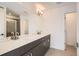 Bright bathroom with a double sink vanity, modern lighting, and a tiled floor at 370 N. Geneva St, Aurora, CO 80010