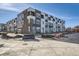 Modern townhome featuring stylish brick and siding, set against a clear blue sky at 370 N. Geneva St, Aurora, CO 80010