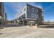 Rear exterior view of townhomes, featuring private garages and modern design at 370 N. Geneva St, Aurora, CO 80010