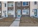 Attractive new two-story townhomes with a brick facade and concrete walkway to the entrance at 370 N. Geneva St, Aurora, CO 80010