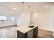 Bright kitchen island with stainless steel dishwasher and sink with quartz countertop at 370 N. Geneva St, Aurora, CO 80010