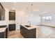 Bright kitchen with island, modern cabinets, stainless steel appliances, and hardwood floor at 370 N. Geneva St, Aurora, CO 80010