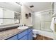 Bathroom features a shower and tub combo, vanity with sink, and tiled floors at 3339 S Monaco Pkwy # A, Denver, CO 80222
