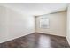 Bedroom features a hardwood floor and large window at 3339 S Monaco Pkwy # A, Denver, CO 80222