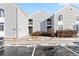Gray siding townhouse exterior with small front yard and parking lot at 3339 S Monaco Pkwy # A, Denver, CO 80222