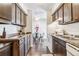 Eat-in kitchen with dark wood cabinets and modern appliances at 3339 S Monaco Pkwy # A, Denver, CO 80222