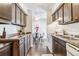 Kitchen boasts wood cabinets, laminate countertops, and a view into the dining area at 3339 S Monaco Pkwy # A, Denver, CO 80222
