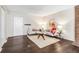 Open concept living room with hardwood floors, modern sofas, and an eye-catching center table at 3339 S Monaco Pkwy # A, Denver, CO 80222