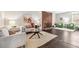 Bright living room featuring a brick fireplace, hardwood floors, and contemporary furnishings at 3339 S Monaco Pkwy # A, Denver, CO 80222
