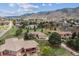 Panoramic aerial view displays the neighborhood with mountain views and other beautiful homes at 11064 Hermitage Run, Littleton, CO 80125