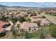 Stunning aerial view of a luxury home nestled within a picturesque neighborhood landscape at 11064 Hermitage Run, Littleton, CO 80125