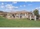 An alluring outdoor living space showcases a spacious deck and lush lawn, perfect for relaxation and entertainment at 11064 Hermitage Run, Littleton, CO 80125