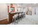 Basement bar with wooden accents and seating in finished basement area at 11064 Hermitage Run, Littleton, CO 80125