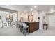 Finished basement bar area with wood paneling, stone countertop, and seating at 11064 Hermitage Run, Littleton, CO 80125