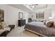 Comfortable basement bedroom with a dresser, mirror, and a window at 11064 Hermitage Run, Littleton, CO 80125