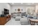 Finished basement living room with sectional, TV, and decor shelf at 11064 Hermitage Run, Littleton, CO 80125