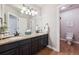 Elegant bathroom with double vanity, granite countertop, and a walk-in shower at 11064 Hermitage Run, Littleton, CO 80125