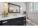 Bathroom features a modern vanity with gold hardware, a large mirror, and decorative tile at 11064 Hermitage Run, Littleton, CO 80125