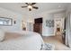 Bright bedroom with hardwood floors, large TV, and modern decor at 11064 Hermitage Run, Littleton, CO 80125