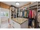 Walk-in closet with custom shelving and granite-topped island for storage at 11064 Hermitage Run, Littleton, CO 80125