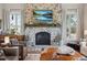 Cozy living area with a stone fireplace and decorative mantel, creating a warm and inviting atmosphere at 11064 Hermitage Run, Littleton, CO 80125
