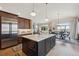 The kitchen features custom cabinets, stainless steel appliances, a large center island, and an adjacent dining area at 11064 Hermitage Run, Littleton, CO 80125