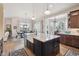 Bright kitchen showcases a center island, hardwood floors, stainless steel appliances, and a view of the outdoor scenery at 11064 Hermitage Run, Littleton, CO 80125