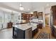 This kitchen features a large island, hardwood floors, custom cabinets, and seamlessly connects to the breakfast nook at 11064 Hermitage Run, Littleton, CO 80125